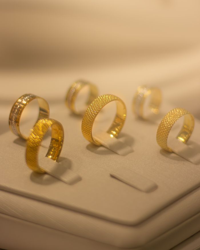 contact-img Luxurious gold rings displayed elegantly, perfect for weddings and special occasions.